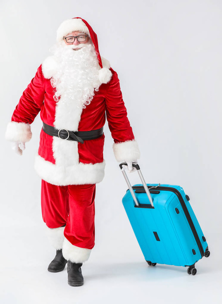 Santa Claus with luggage on white background - Zdjęcie, obraz