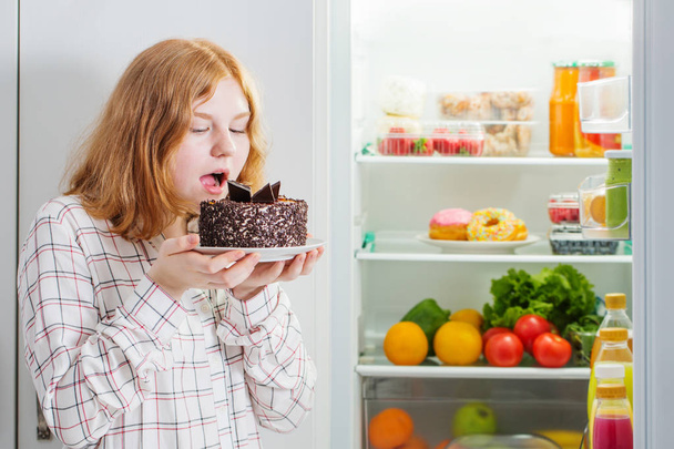 teenager girl at fridge with food - Fotoğraf, Görsel