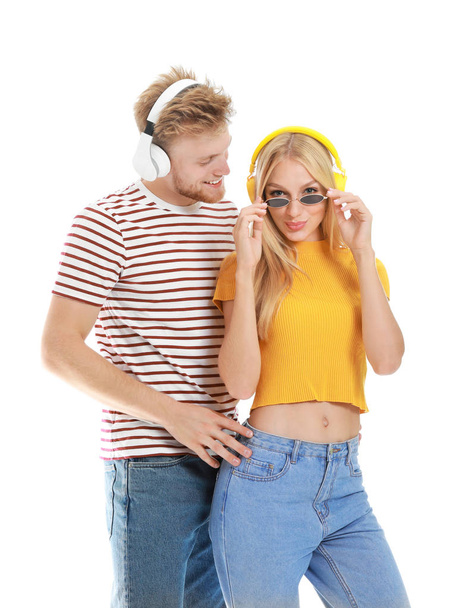 Young couple listening to music on white background - Foto, Imagem