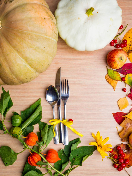 Thanksgiving dinner background with pumpkins, fall leaves, table setting, physalis, apple, top view, copy space. - Photo, Image