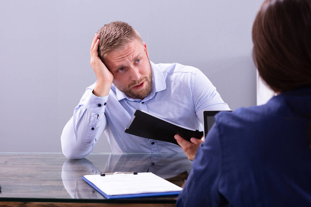 Stressed Young Business Man Holding His Head At Interview In Office - Photo, Image