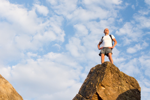 Successful male hiker standing on the mountain top - Photo, Image