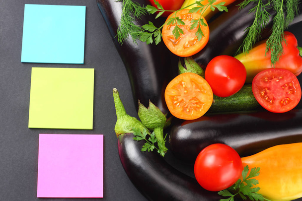 Assortment of fresh raw vegetables on black background. Tomato, eggplant, onion, pepper, parsley, spices. Top view  - Φωτογραφία, εικόνα