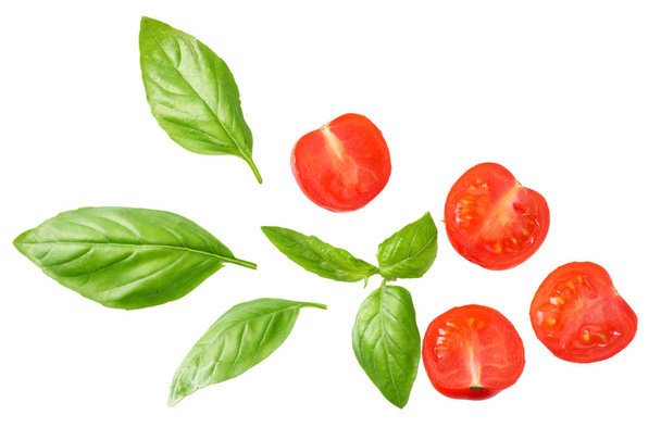 Basil leaves with tomato slices isolated on white background. Top view.  - Foto, afbeelding