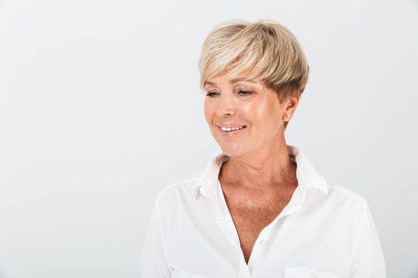 Portrait of positive adult woman with short blond hair smiling a - Photo, image