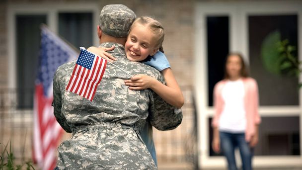 Cheerful daughter hugging father soldier, long awaited meeting, homecome - Foto, Bild