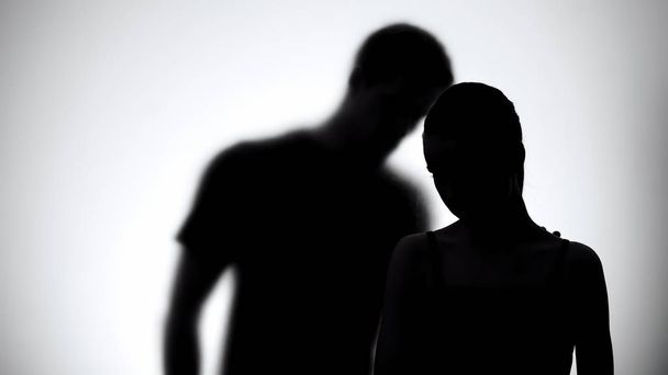 Silhouettes of upset woman and man together, experiencing life difficulties - Φωτογραφία, εικόνα