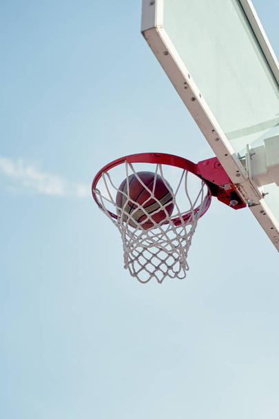 Photo of basketball hoop against blue sky . - Fotografie, Obrázek