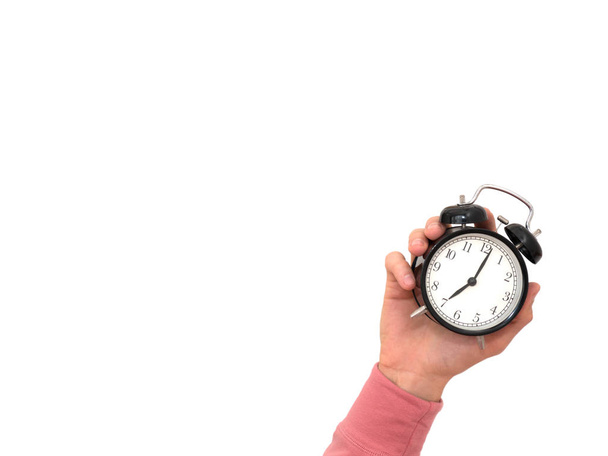 Male hand holding alarm clock isolated on white background - Photo, image