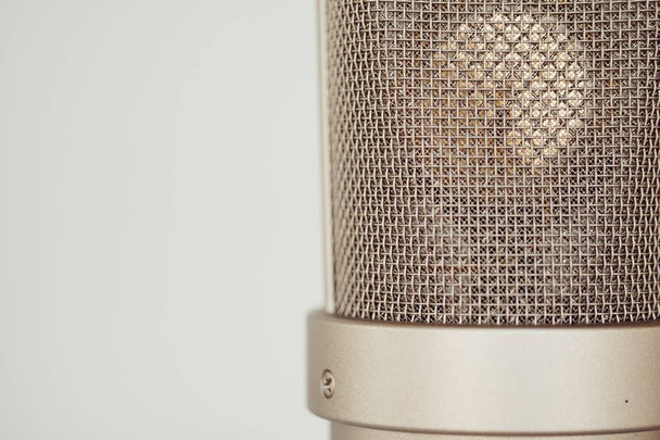 A closeup shot of a silver professional studio condenser microphone  on a white background - Fotoğraf, Görsel