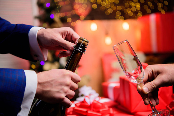 New year countdown. Hands opening champagne bottle and hold glass christmas decorations background. Last minute before new year. Drink champagne or sparkling wine. Celebrate new year with champagne - Φωτογραφία, εικόνα