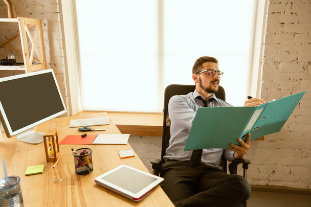 A young businessman working in office after promotion - Photo, Image