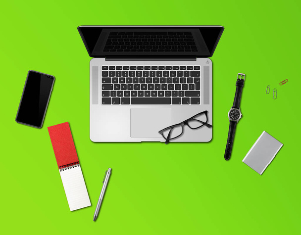 Office desk mockup top view isolated on green - Foto, imagen