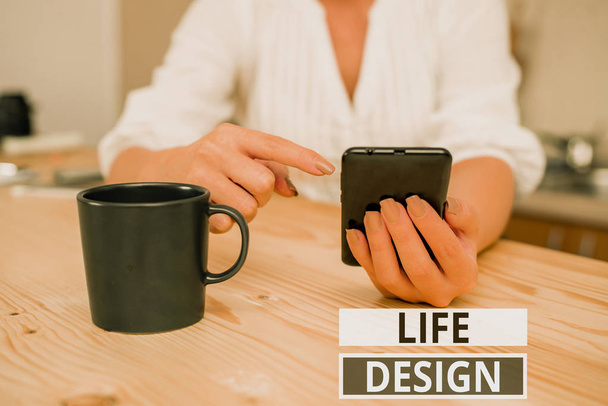 Text sign showing Life Design. Conceptual photo balance how you live between work family and entertaining woman using smartphone office supplies technological devices inside home. - Photo, Image