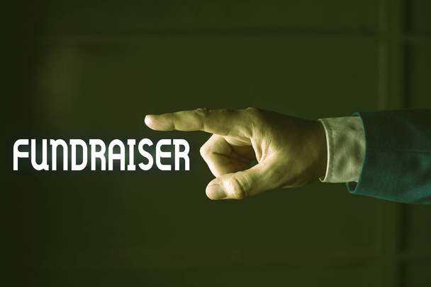 Fundraiser yazma el yazısı metin. Kavram anlamı kimin iş veya görev sadaka izole el parmak ile işaret için mali destek aramak olduğunu gösteren. İş kavramı işaret parmağı. - Fotoğraf, Görsel