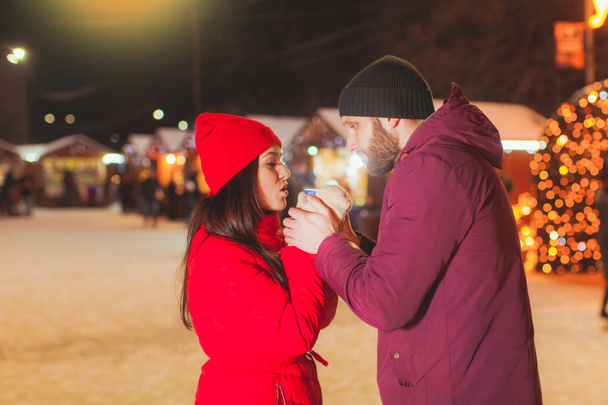 Warm portrait of man and woman holding cup of hot drink together - Foto, Imagem