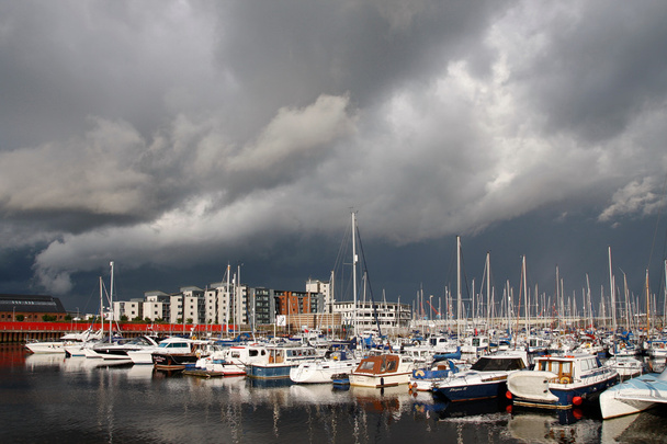 Boats in a marina with a dark sky - Foto, Imagen