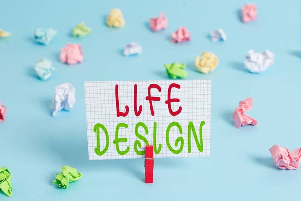 Conceptual hand writing showing Life Design. Business photo showcasing balance how you live between work family and entertaining Colored clothespin rectangle shaped paper blue background. - Photo, Image