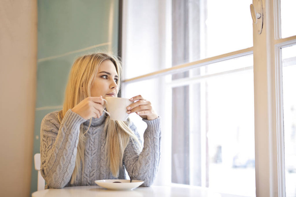 Blonde girl have a breakfast - Фото, изображение