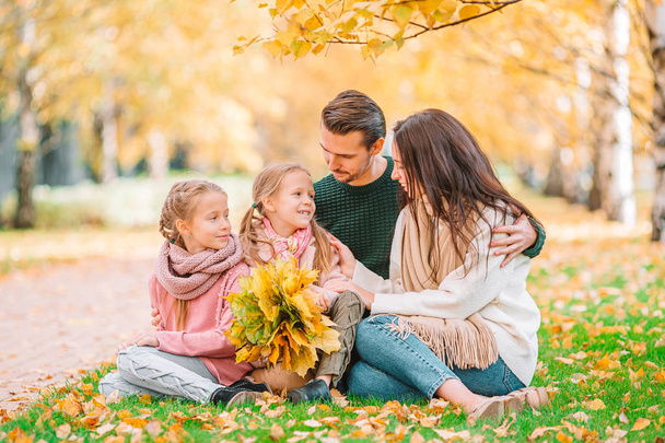 Portrait of happy family of four in autumn day - Photo, Image
