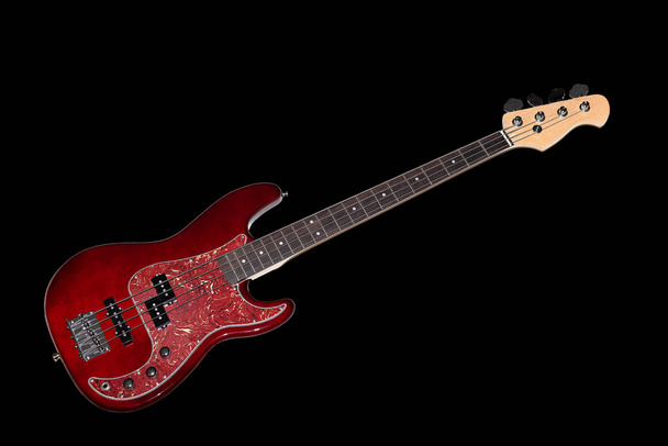 Bass guitar in cherry-colored wood on a black background - Photo, Image