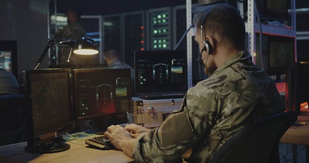 Soldiers controlling rocket launch on computer - Photo, Image