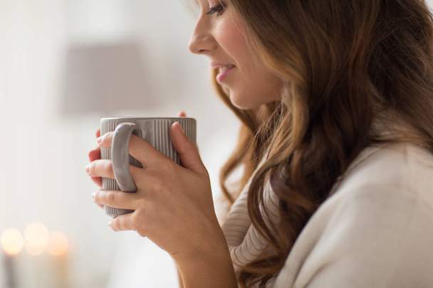 close up of happy woman with cup of coffee at home - Photo, Image