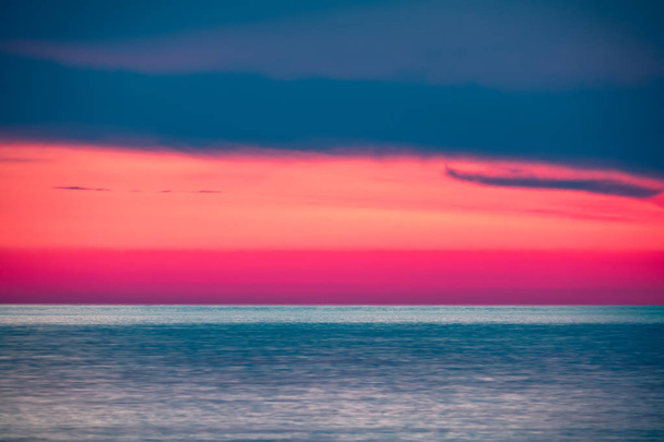 Beautiful pink sunset over the sea. - Zdjęcie, obraz