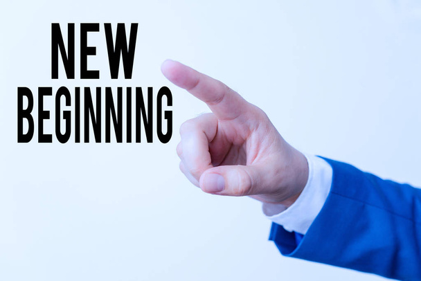 Writing note showing New Beginning. Business photo showcasing Different Career or endeavor Starting again Startup Renew Isolated hand pointing with finger. Business concept pointing finger. - Foto, imagen