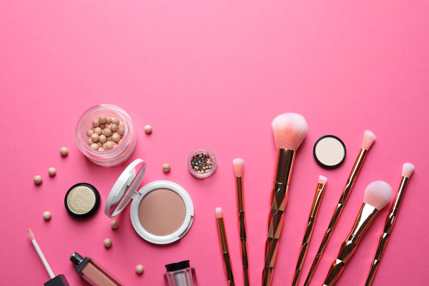 Flat lay composition with makeup brushes on pink background. Space for text - Фото, изображение