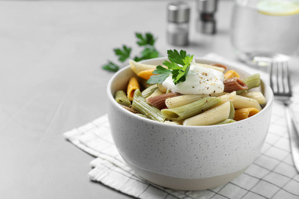 Delicious pasta with sour cream on light grey table - Zdjęcie, obraz