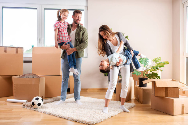 Young couple with their children moving in a new home  - Photo, Image