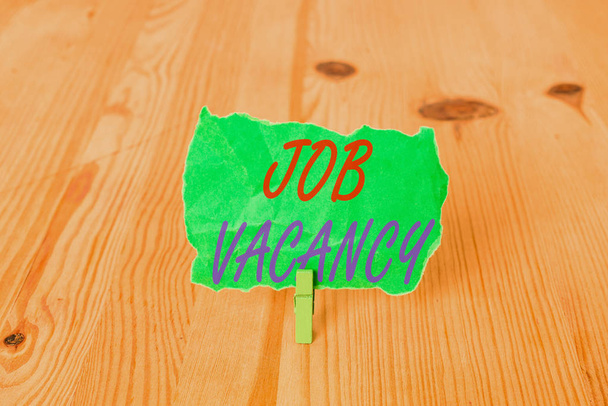 Text sign showing Job Vacancy. Conceptual photo empty or available paid place in small or big company Empty reminder wooden floor background green clothespin groove slot office. - Photo, Image