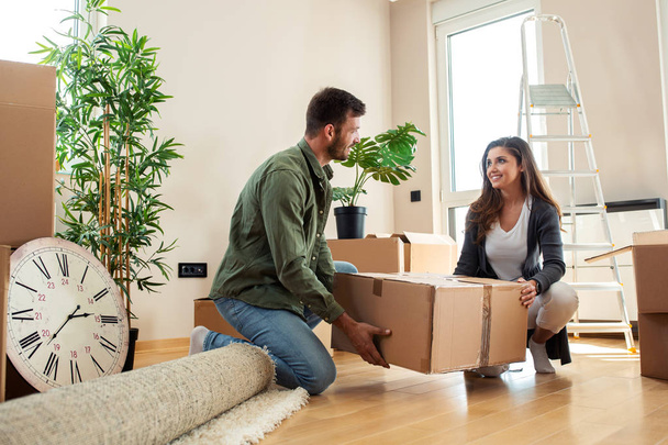 Young couple holding a box for unpacking  - Photo, image