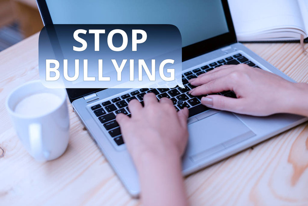 Text sign showing Stop Bullying. Conceptual photo Fight and Eliminate this Aggressive Unacceptable Behavior woman laptop computer smartphone mug office supplies technological devices. - Photo, Image