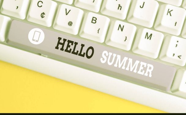 Conceptual hand writing showing Hello Summer. Business photo showcasing Welcoming the warmest season of the year comes after spring White pc keyboard with note paper above the white background. - Photo, Image