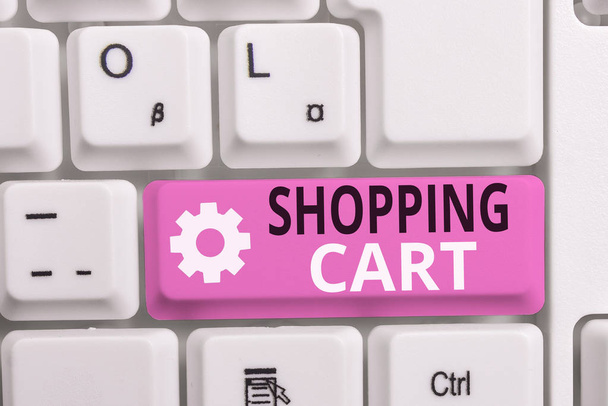 Writing note showing Shopping Cart. Business photo showcasing Case Trolley Carrying Groceries and Merchandise White pc keyboard with note paper above the white background. - Photo, Image