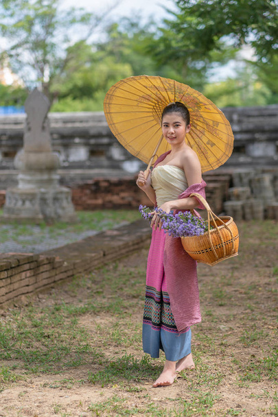 Asian women in beautiful ancient traditional dress antique costume walking in temple of Thailand - Photo, image