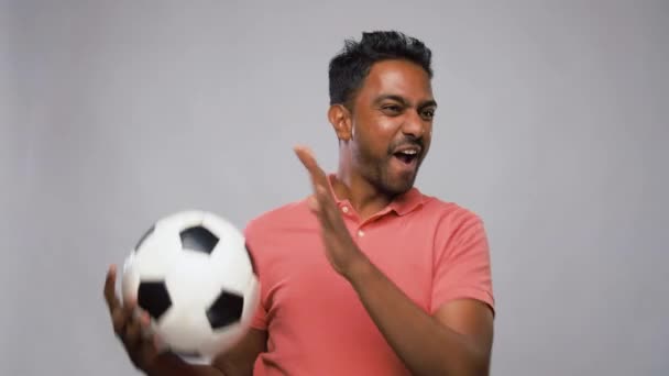 indian man or football fan with soccer ball - Filmati, video