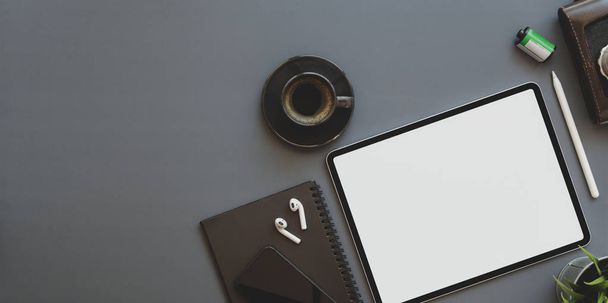 Blank screen tablet with office supplies on trendy photographer workplace - Photo, Image