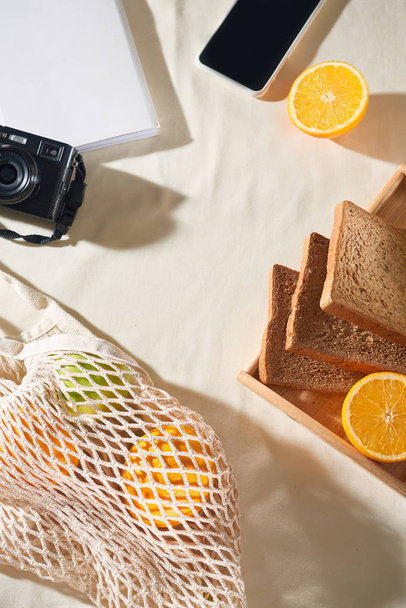 Phone, camera, fruit, bag, notebook and accessories, top view, Flat lay, The concept of a picnic, summer - Photo, Image