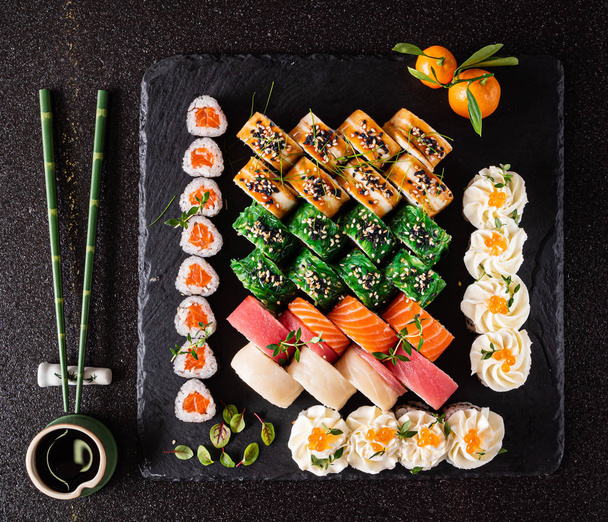 sushi set on the black background, close up - Фото, зображення