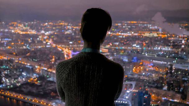 Pensive nő nézi éjszakai város felhőkarcoló - Fotó, kép