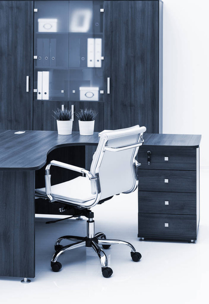 desk, chair and bookcase on white wall - Foto, immagini