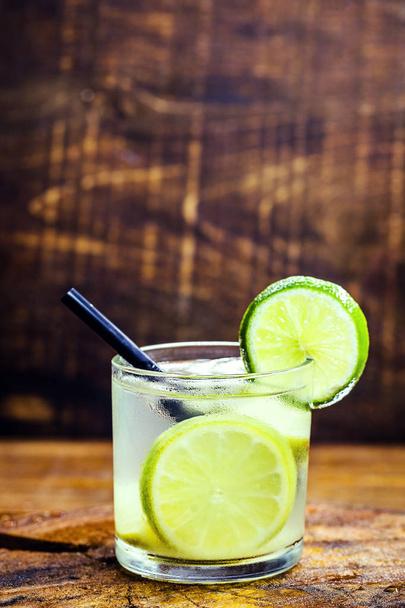 Caipirinha, a typical Brazilian cocktail made with lemon, cachaca, sugar and ice. Brazilian traditional drink, isolated with space for text. - Fotó, kép