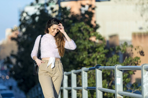 young beautiful woman in casual wear walking outdoors in the city - Fotoğraf, Görsel