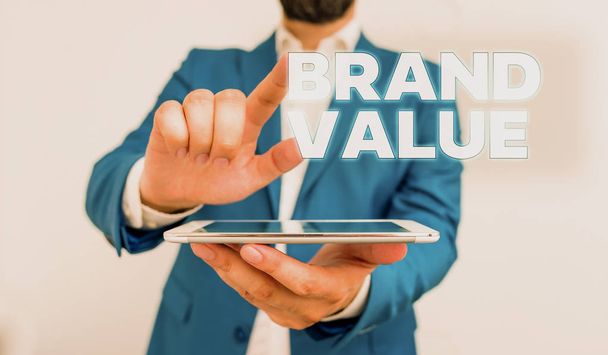 Word szöveg írása Brand Value. Üzleti koncepció a cég generál a termék felismerhető a nevét üzletember a mutatóujját előtte. - Fotó, kép