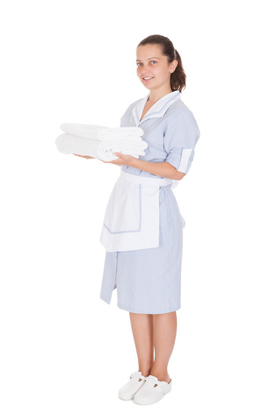 Young Maid Holding Towels - Foto, Imagen