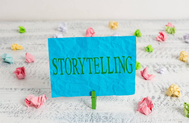 Word writing text Storytelling. Business concept for social and cultural Activity with Theatrical Gestures Green clothespin white wood background colored paper reminder office supply. - 写真・画像