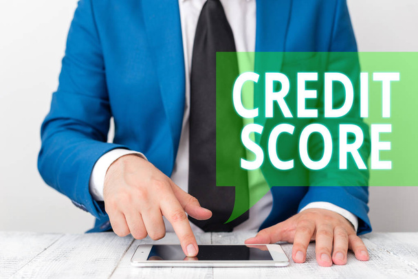 Conceptual hand writing showing Credit Score. Business photo showcasing Represent the creditworthiness of an individual Lenders rating Businessman in blue suite with a tie holds lap top in hands. - Photo, Image